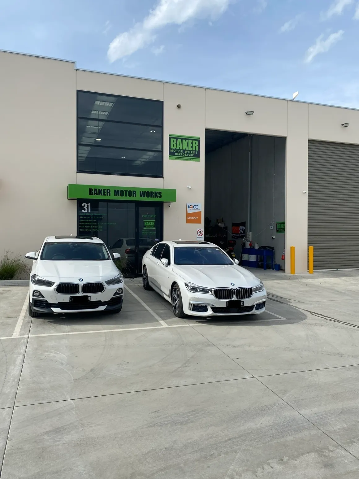 Two BMW vehicles outside Baker Motor Works