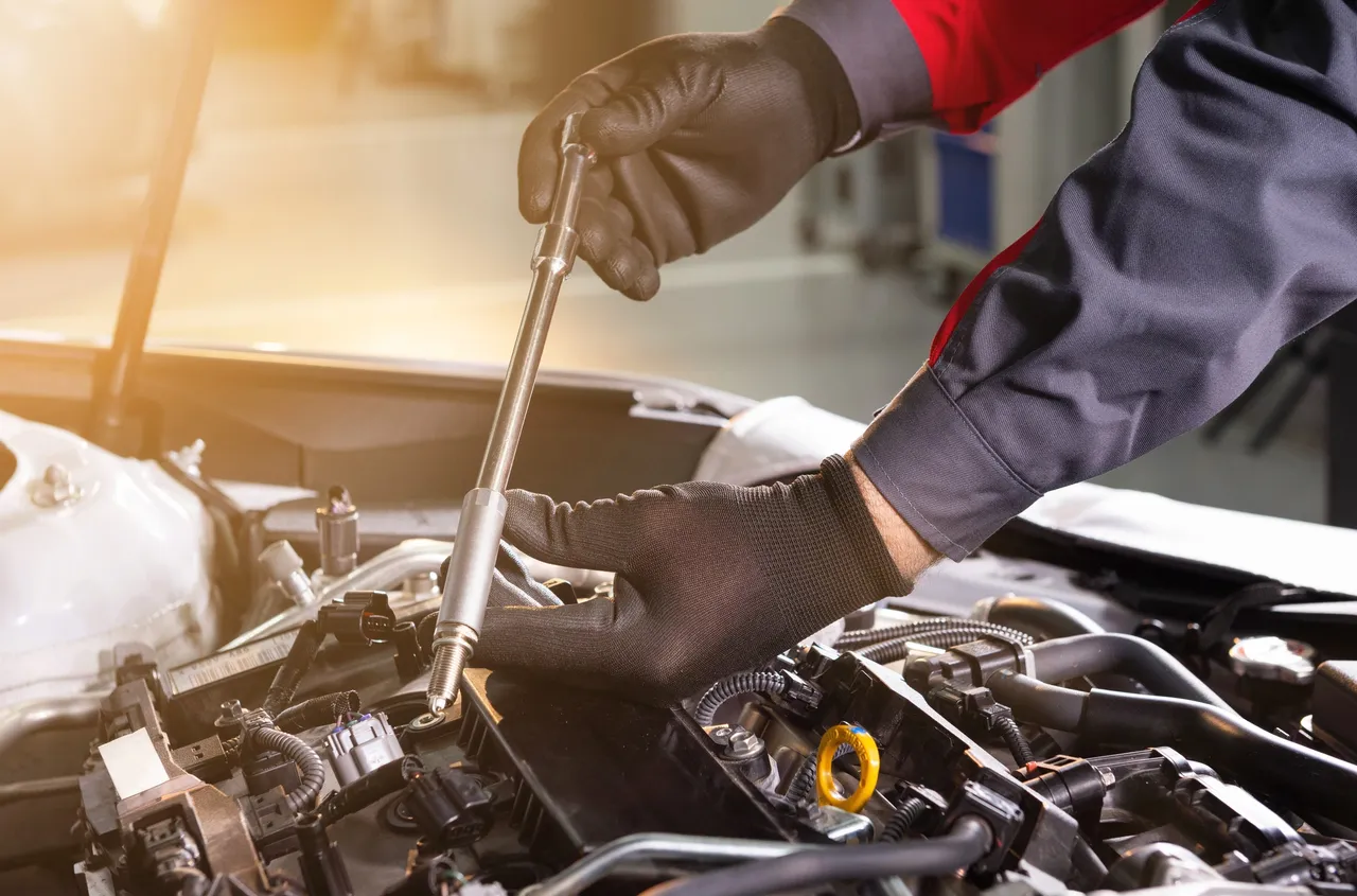 Technician performing engine bay work