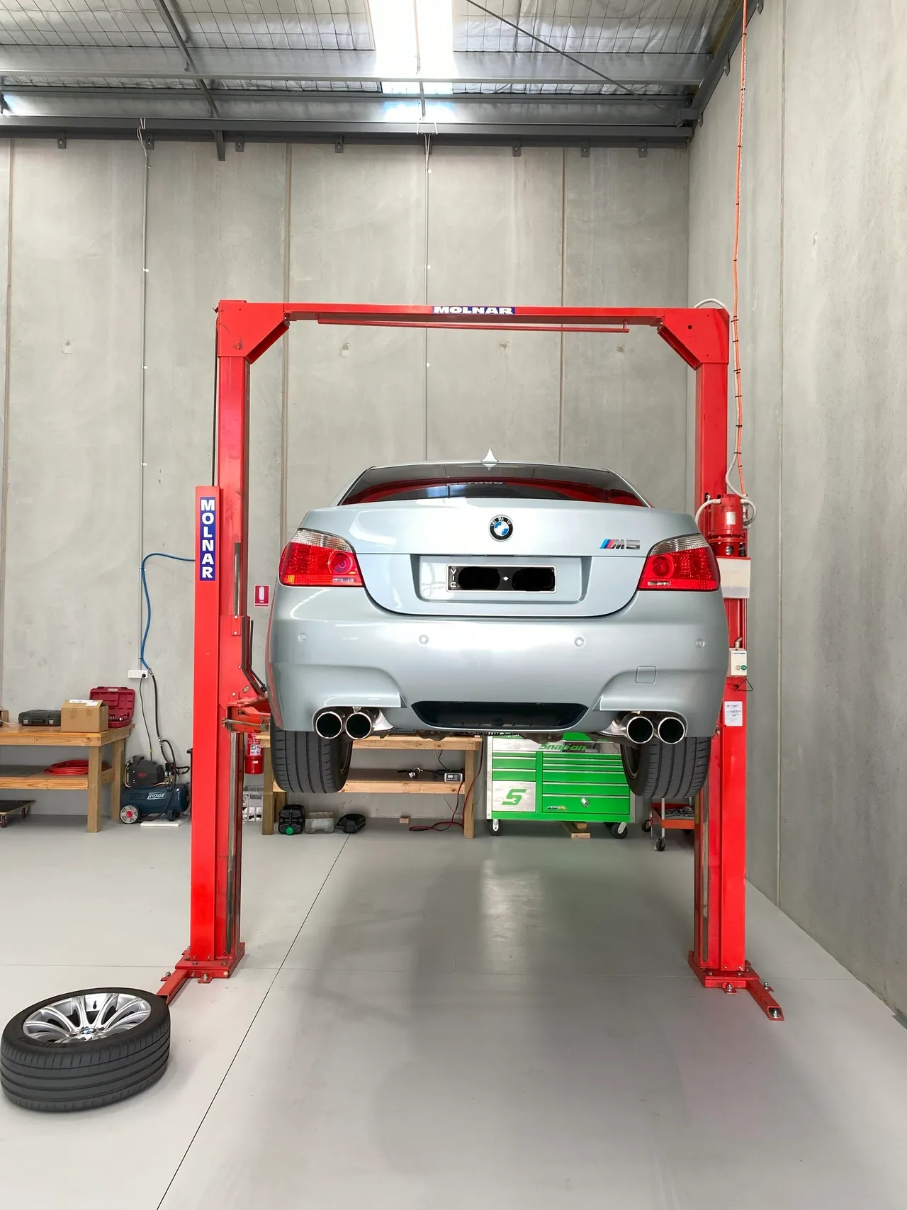 BMW M5 on workshop hoist